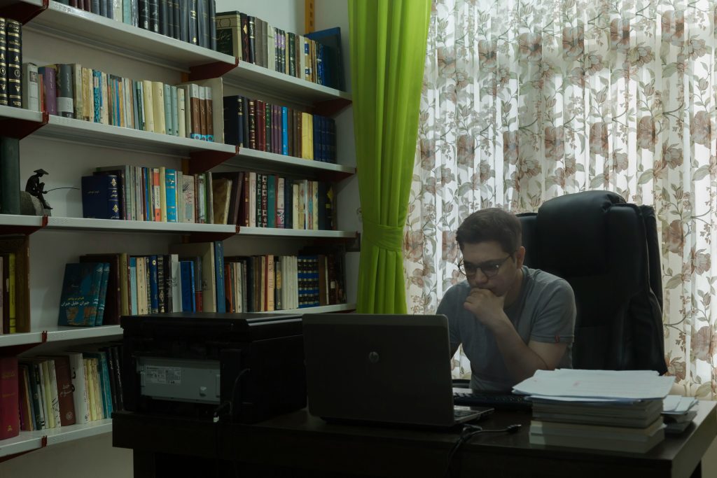 A man in his office focused on his laptop