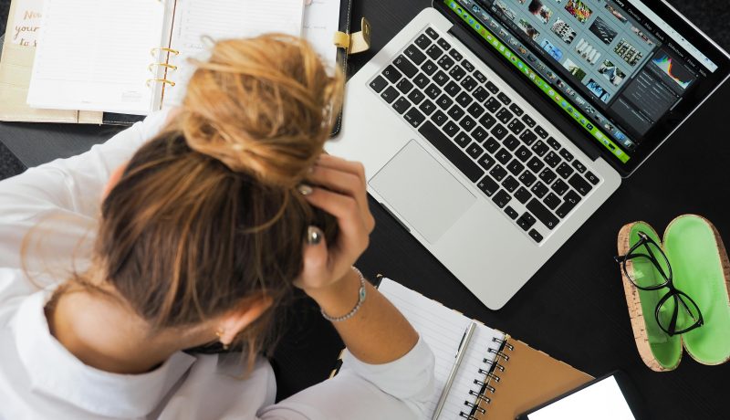 Why do Unfinished tasks steal your focus? The Zeigarnik Effect A woman watching her laptop with a phone on the table