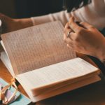 A woman reading through her journal