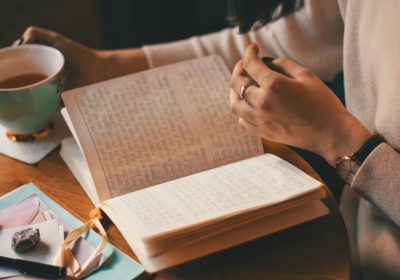 A woman reading through her journal