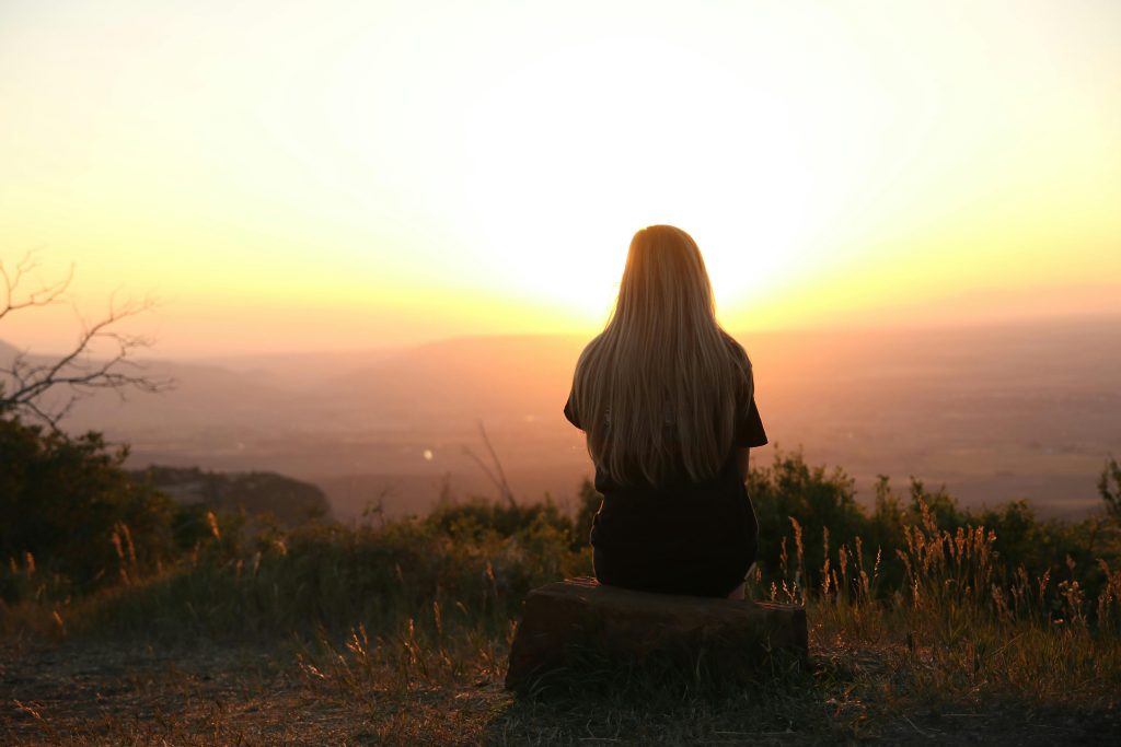 A woman watching the sun rise