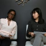 Two women sitting in an office.