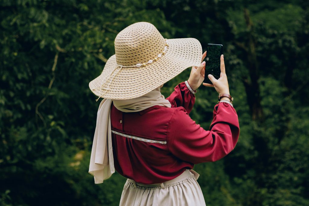 A woman taking pictures in the wild