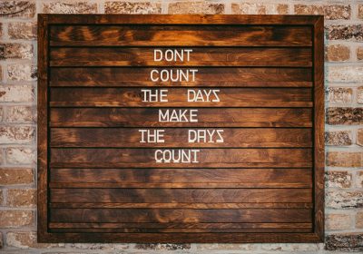 How Ssendagire Ashiraf Overcame Life’s Challenges: 7 Key Lessons for Success in Academics A wall painted with the words "Dont Count The Days Make The Days Count"