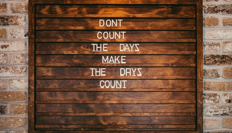 How Ssendagire Ashiraf Overcame Life’s Challenges: 7 Key Lessons for Success in Academics A wall painted with the words "Dont Count The Days Make The Days Count"