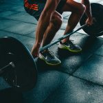 A man in a gym lifting weights