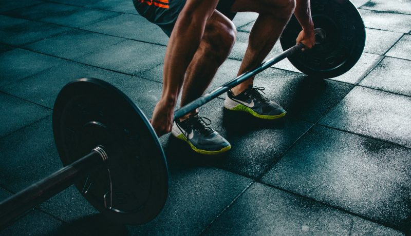 The Four Laws of Behavior Change: How to Create Good Habits and break bad ones A man in a gym lifting weights