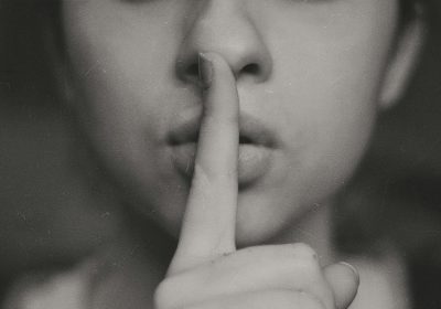 A woman signaling silence
