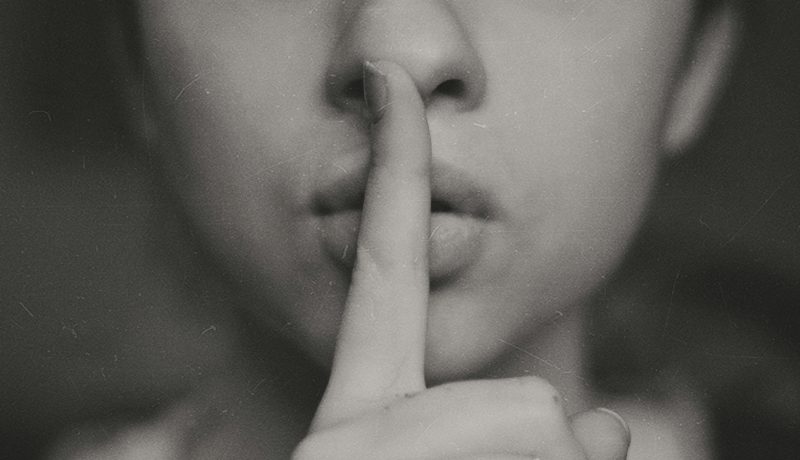 Six Powerful reasons why we should Chase our Goals in Silence A woman signaling silence