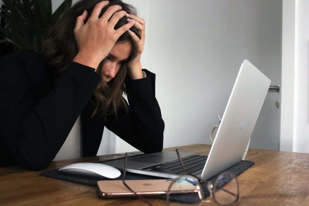 A woman stressed infront of a computer