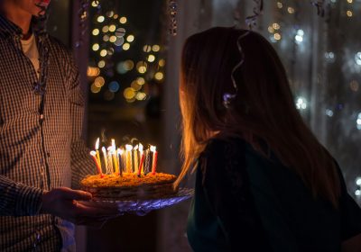 A woman blowing cake candles
