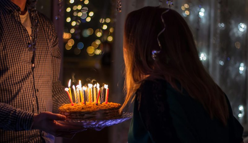 The Importance of Appreciating loved ones on their birthdays A woman blowing cake candles