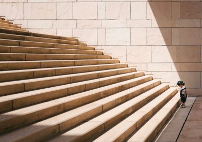 5 Common Challenges That Can Derail Your Goals and How to Overcome Them boy climbing stairs